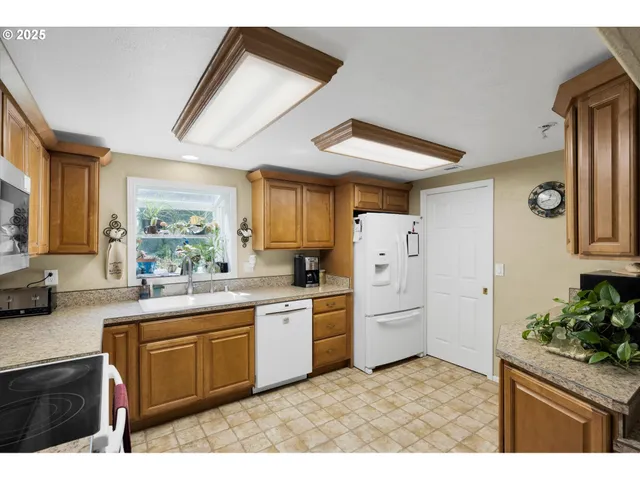 a kitchen with a sink window and cabinets