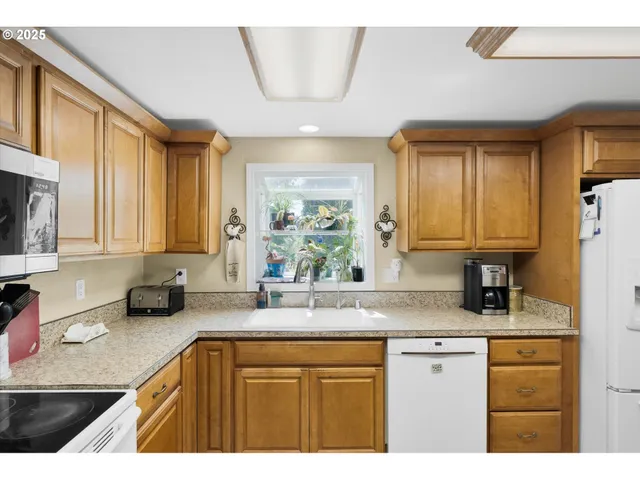 a kitchen with stainless steel appliances granite countertop a sink stove and cabinets