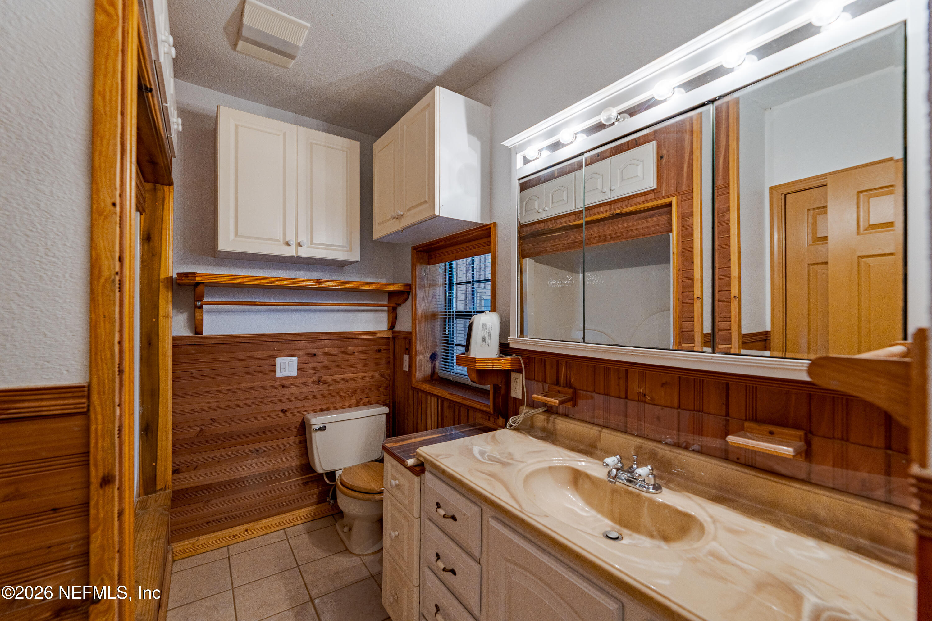 11053 Mulberry Landing Road Hilliard, FL 32046 - Photo 19 of 107 a bathroom with a sink double vanity granite and a window