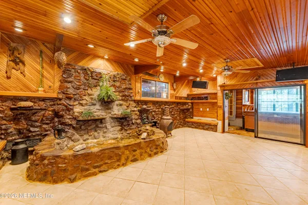 a view of a yard with plants and trees