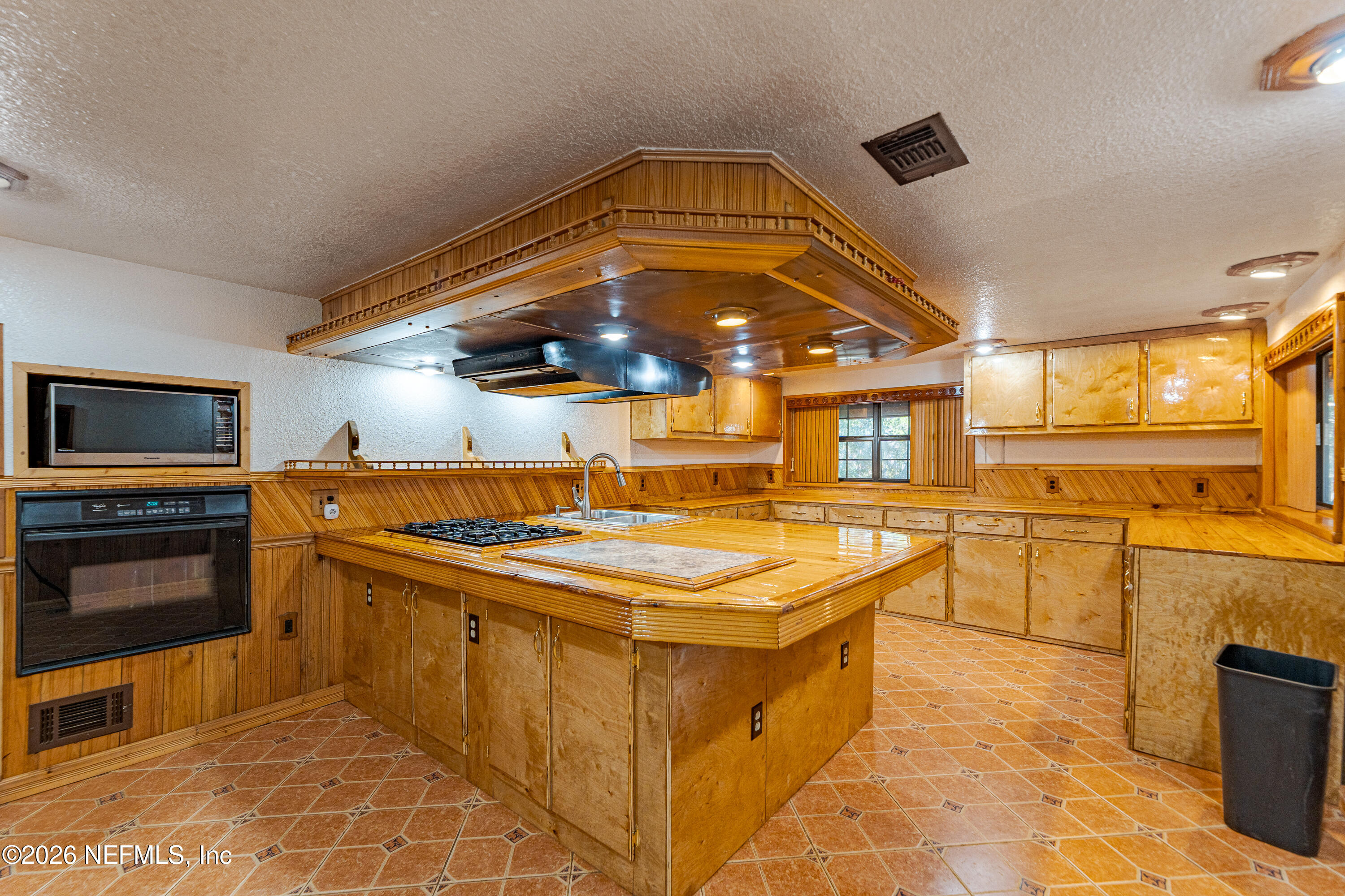 11053 Mulberry Landing Road Hilliard, FL 32046 - Photo 51 of 107 a kitchen with stainless steel appliances granite countertop a stove and a sink