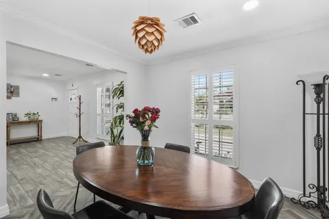 a kitchen with stainless steel appliances granite countertop a table and chairs in it