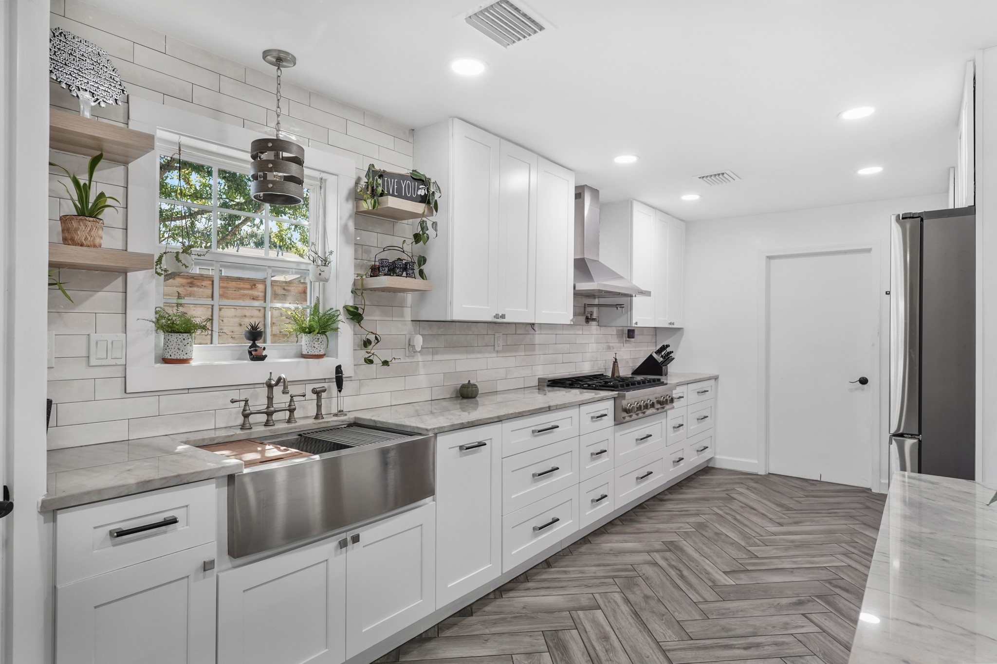 1441 Bingle Road Houston, TX 77055 - Photo 16 of 46 a kitchen with a sink stove and cabinets
