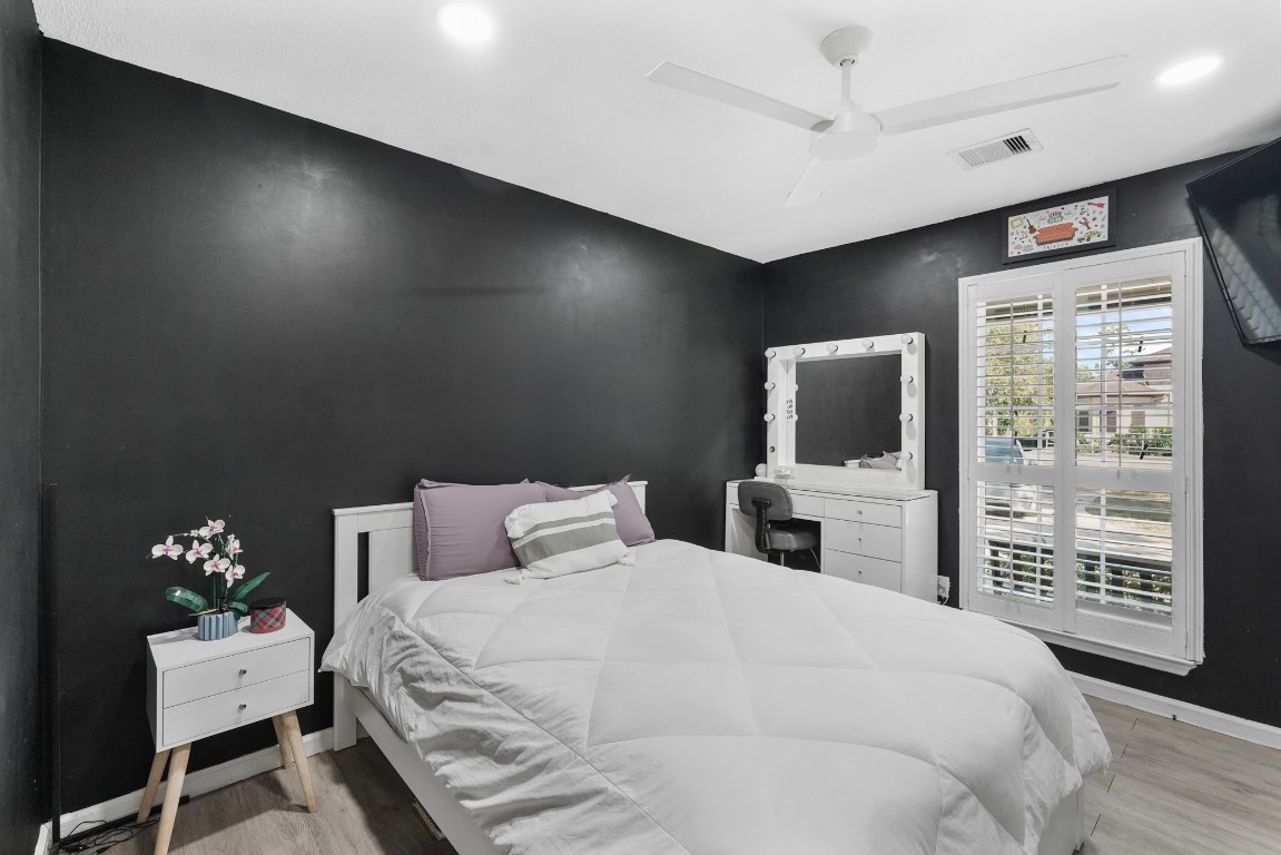 1441 Bingle Road Spring Valley Village, TX 77055 - Photo 32 of 46 a bedroom with a balcony a bed and a flat screen tv