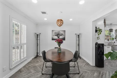 a living room with furniture and kitchen view