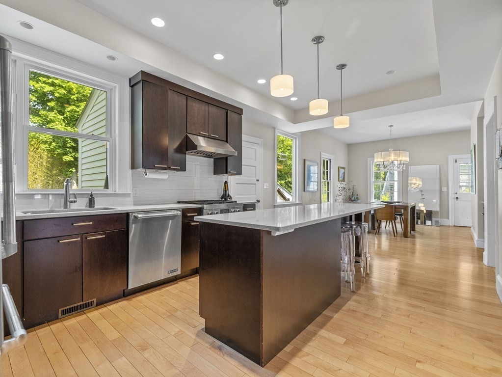 6 Appleby Road Wellesley, MA 02482 - Photo 6 of 21 a open kitchen with stainless steel appliances granite countertop a stove a sink a oven a dining table and chairs with wooden floor