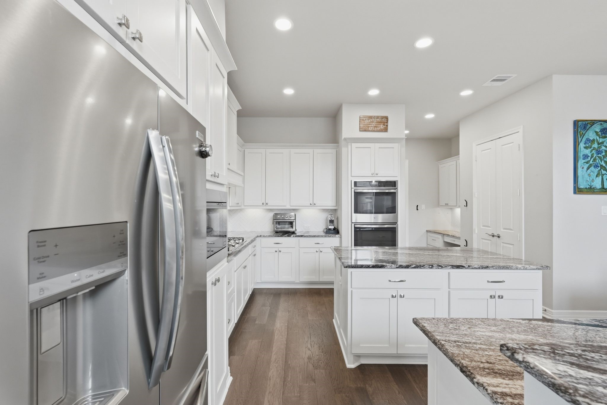 27705 South Slate Hills Lane Spring, TX 77386 - Photo 10 of 45 Bright kitchen views showcasing dual built-in ovens and high-end stainless steel appliances.