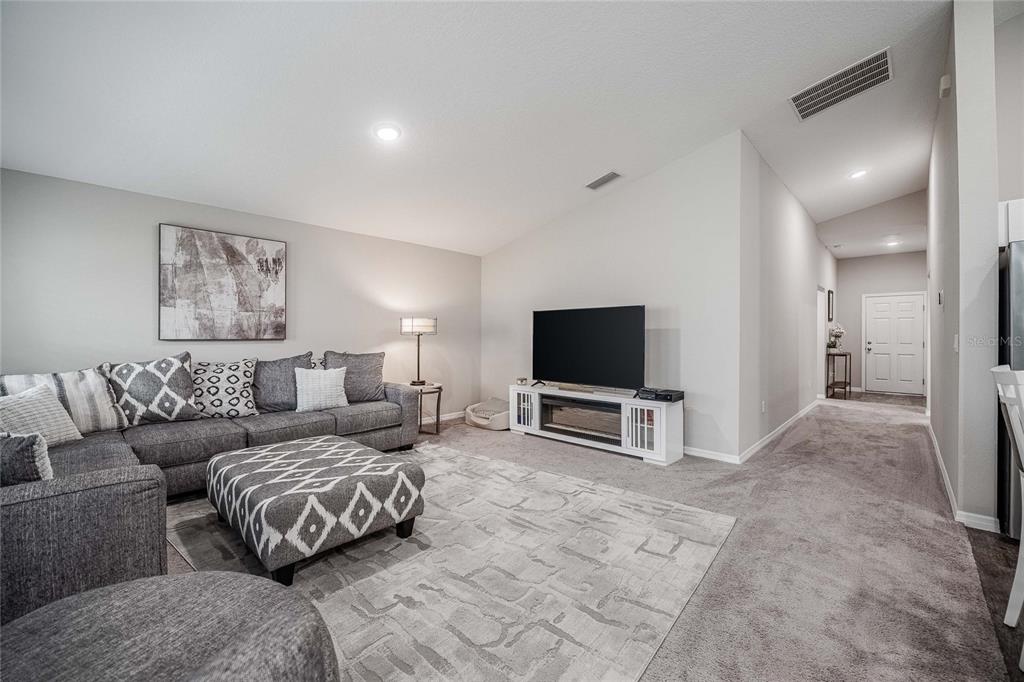 1719 Durden Road Winter Haven, FL 33880 - Photo 16 of 39 a living room with furniture and a flat screen tv