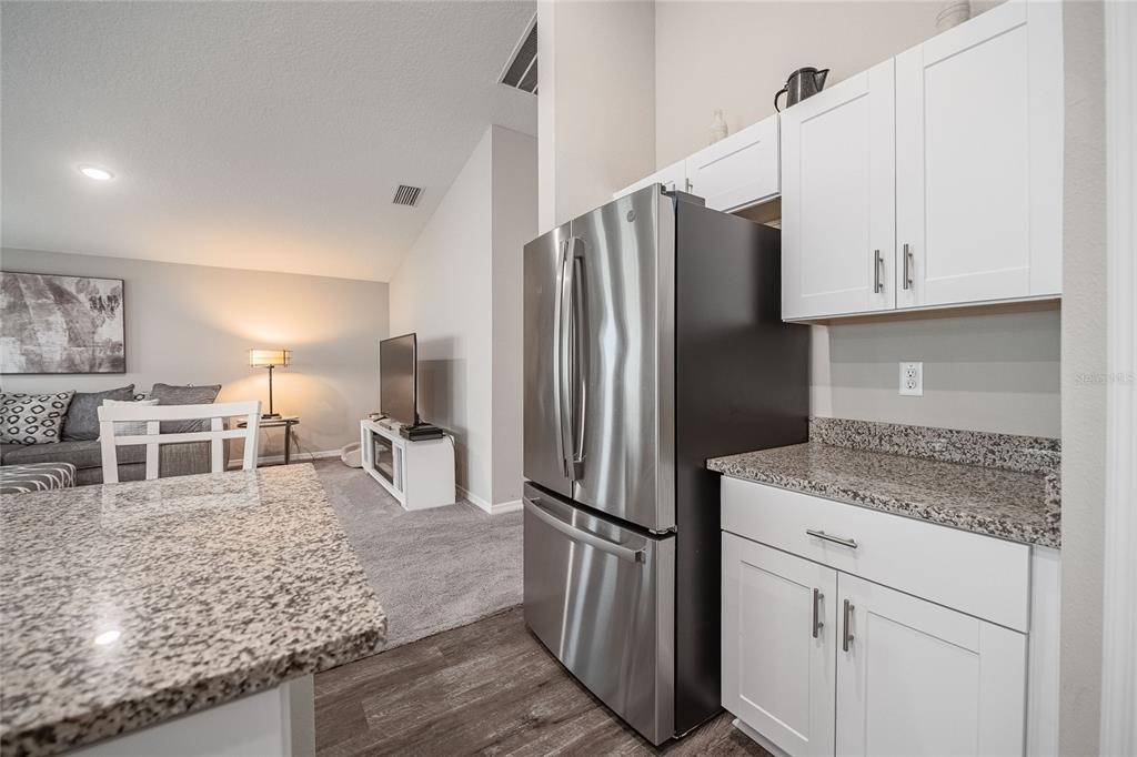 1719 Durden Road Winter Haven, FL 33880 - Photo 20 of 39 a kitchen with stainless steel appliances granite countertop a refrigerator and a sink