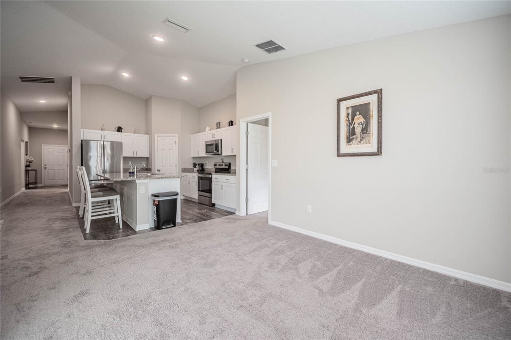 1719 Durden Road Winter Haven, FL 33880 - Photo 25 of 39 a view of a kitchen with chairs and refrigerator