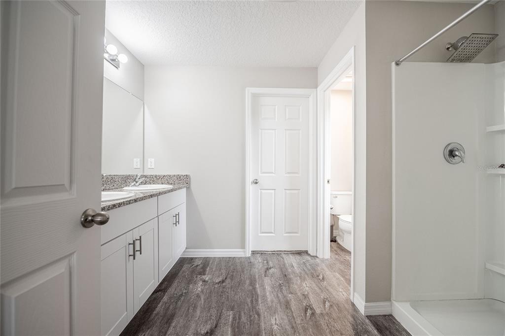 1719 Durden Road Winter Haven, FL 33880 - Photo 30 of 39 a view of a kitchen with white cabinets and wooden floor