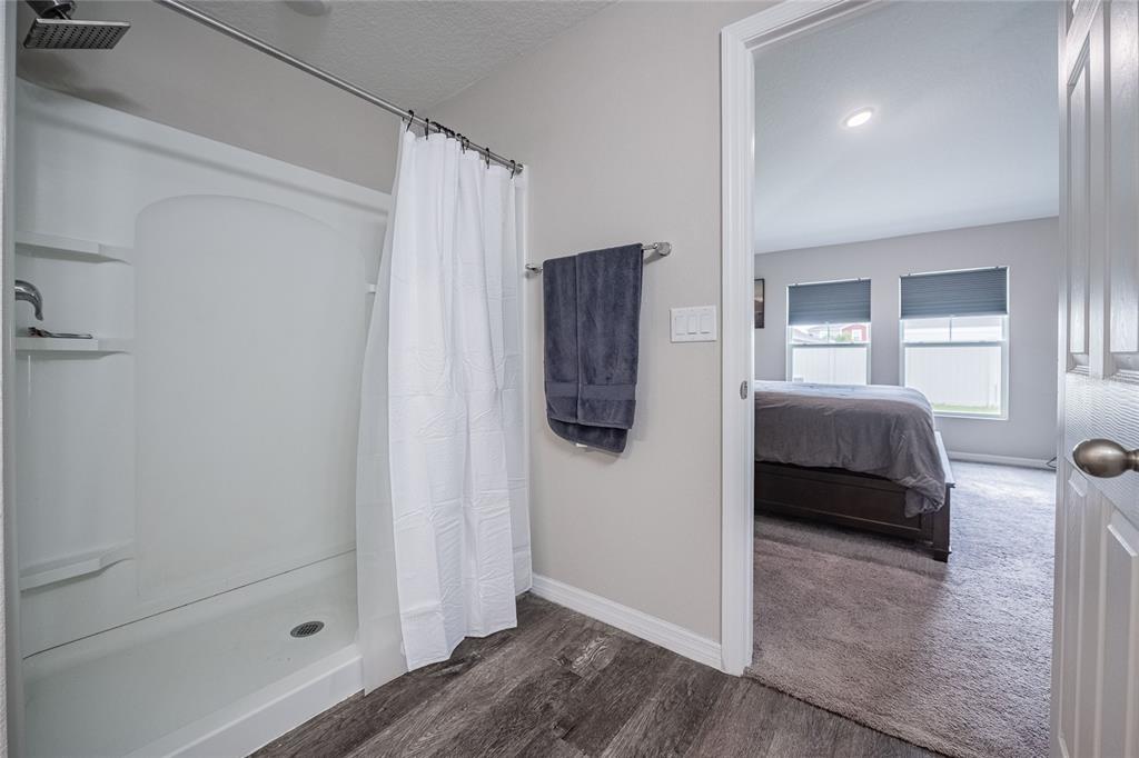 1719 Durden Road Winter Haven, FL 33880 - Photo 31 of 39 a bedroom with a bed and a walk in closet