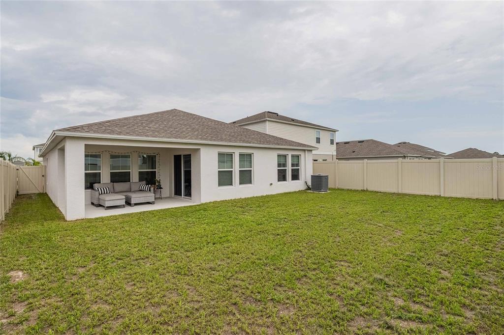 1719 Durden Road Winter Haven, FL 33880 - Photo 34 of 39 a front view of a house with a garden and yard