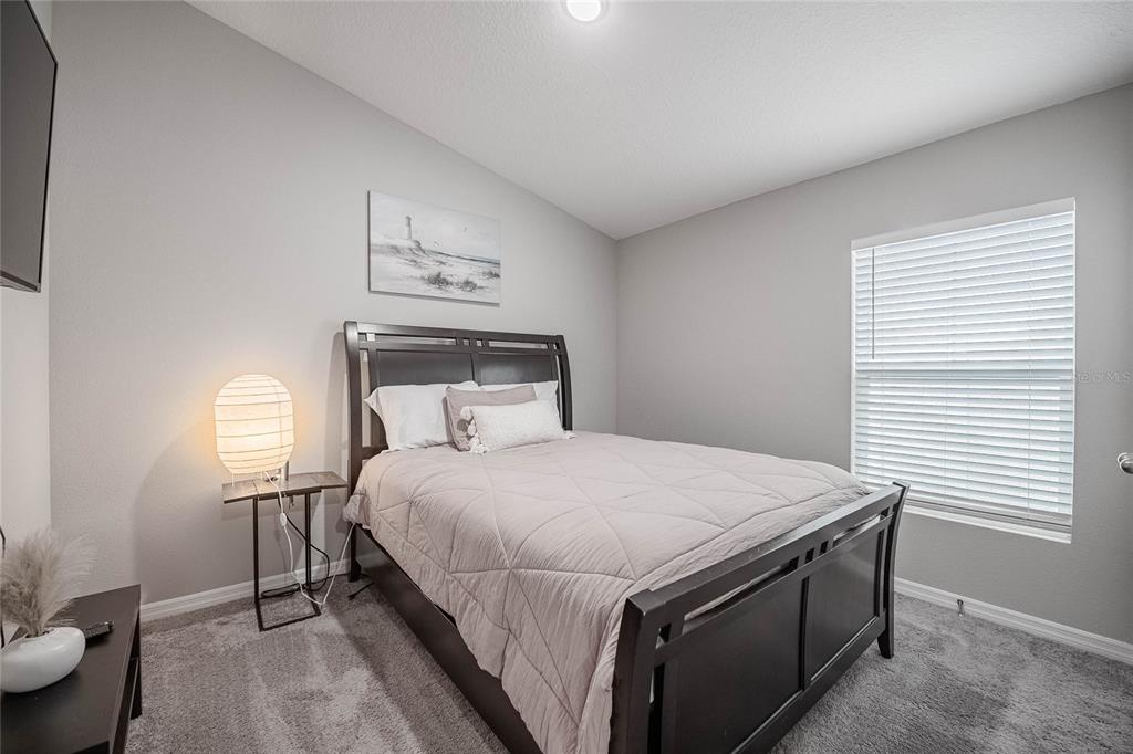 1719 Durden Road Winter Haven, FL 33880 - Photo 7 of 39 a bedroom with a bed and a window