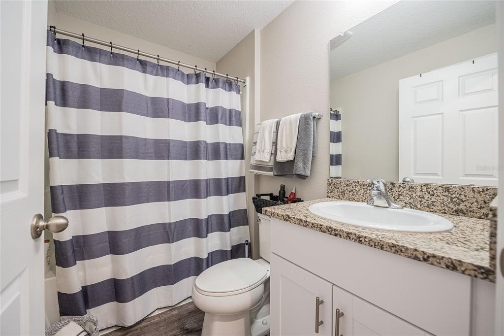 1719 Durden Road Winter Haven, FL 33880 - Photo 9 of 39 a bathroom with a sink a toilet a mirror and shower