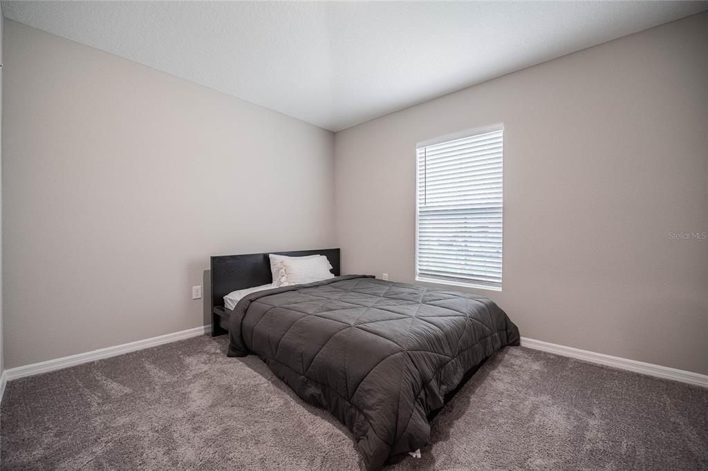 1719 Durden Road Winter Haven, FL 33880 - Photo 10 of 39 a bedroom with a bed and a window