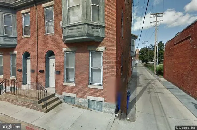 a view of a brick house with many windows