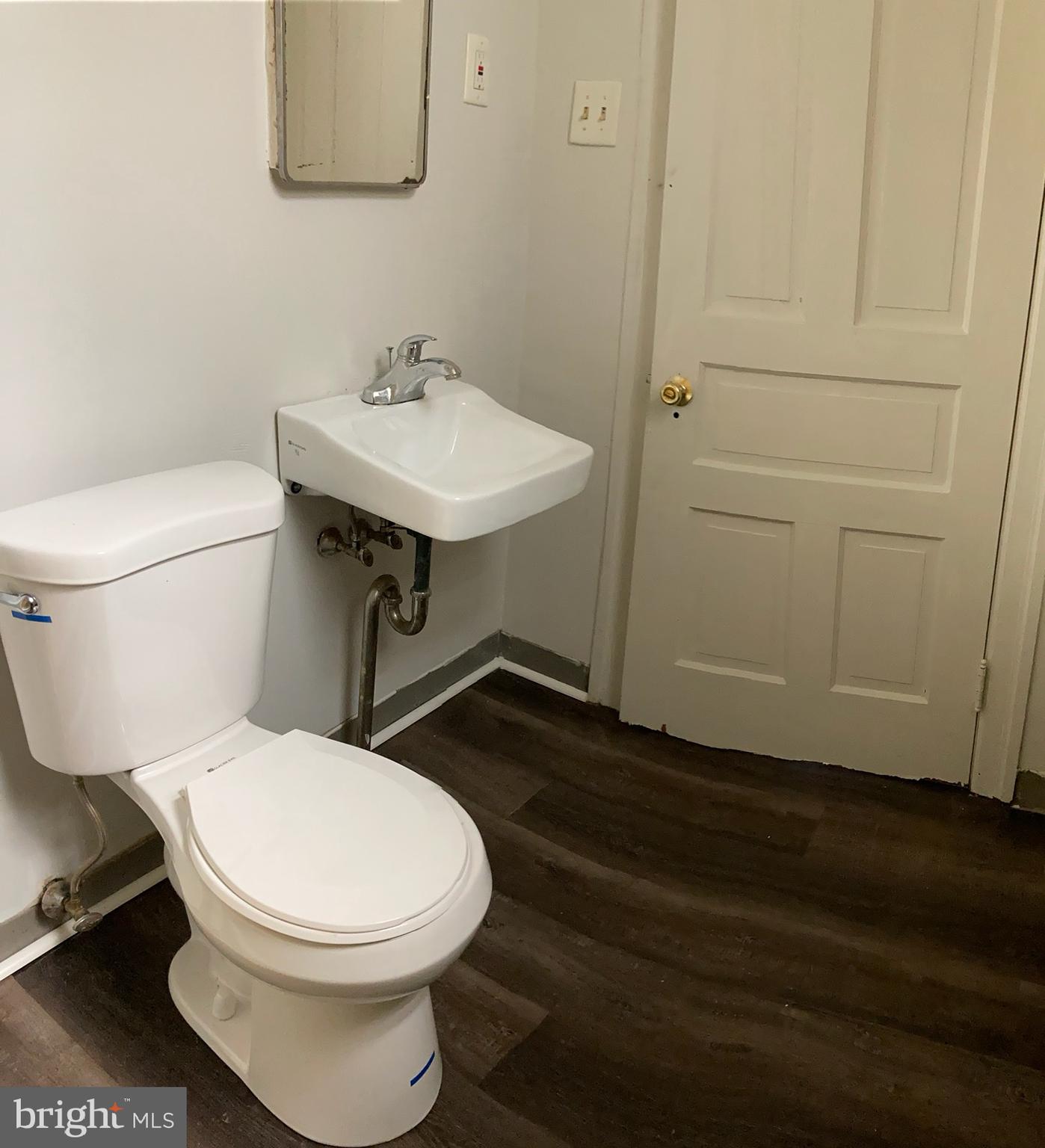 25 South Locust Street Hagerstown, MD 21740 - Photo 35 of 54 a white toilet sitting next to a bathroom sink