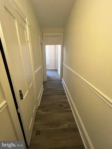 a view of a room with wooden floor and window