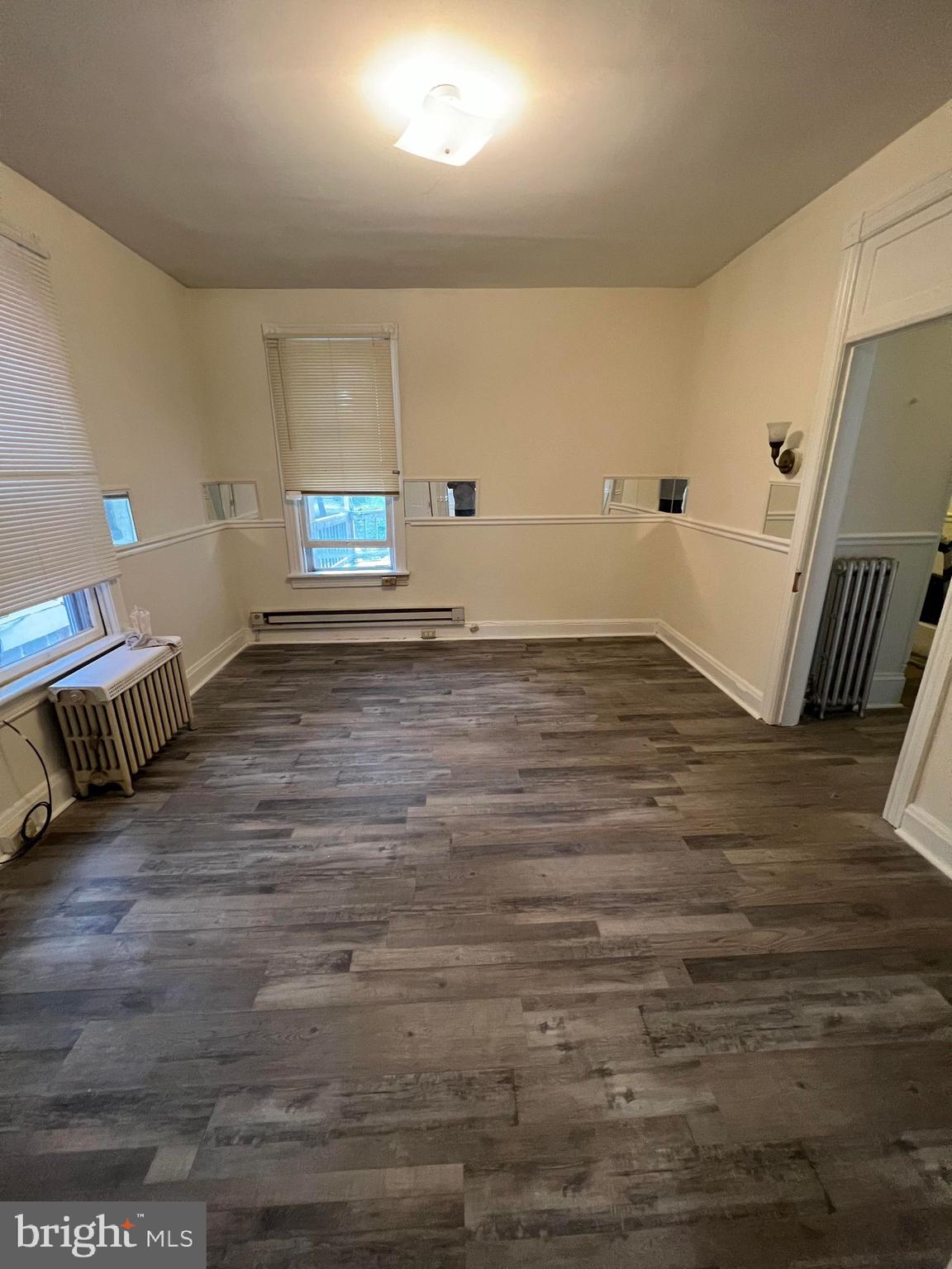 25 South Locust Street Hagerstown, MD 21740 - Photo 49 of 54 a view of an empty room with wooden floor and a window