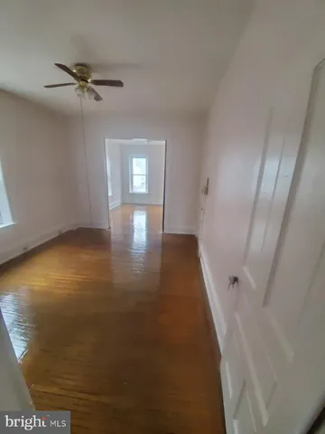 a view of a livingroom with a hardwood floor and a ceiling fan