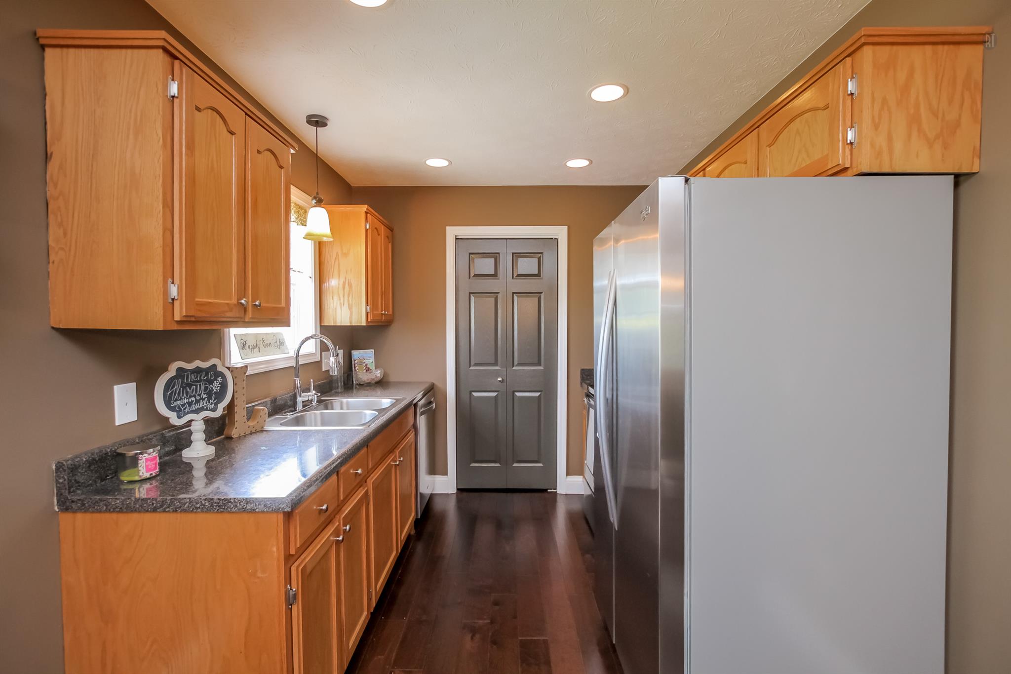 6144 South Lamont Road Springfield, TN 37172 - Photo 9 of 29 a kitchen with stainless steel appliances granite countertop a sink and a refrigerator