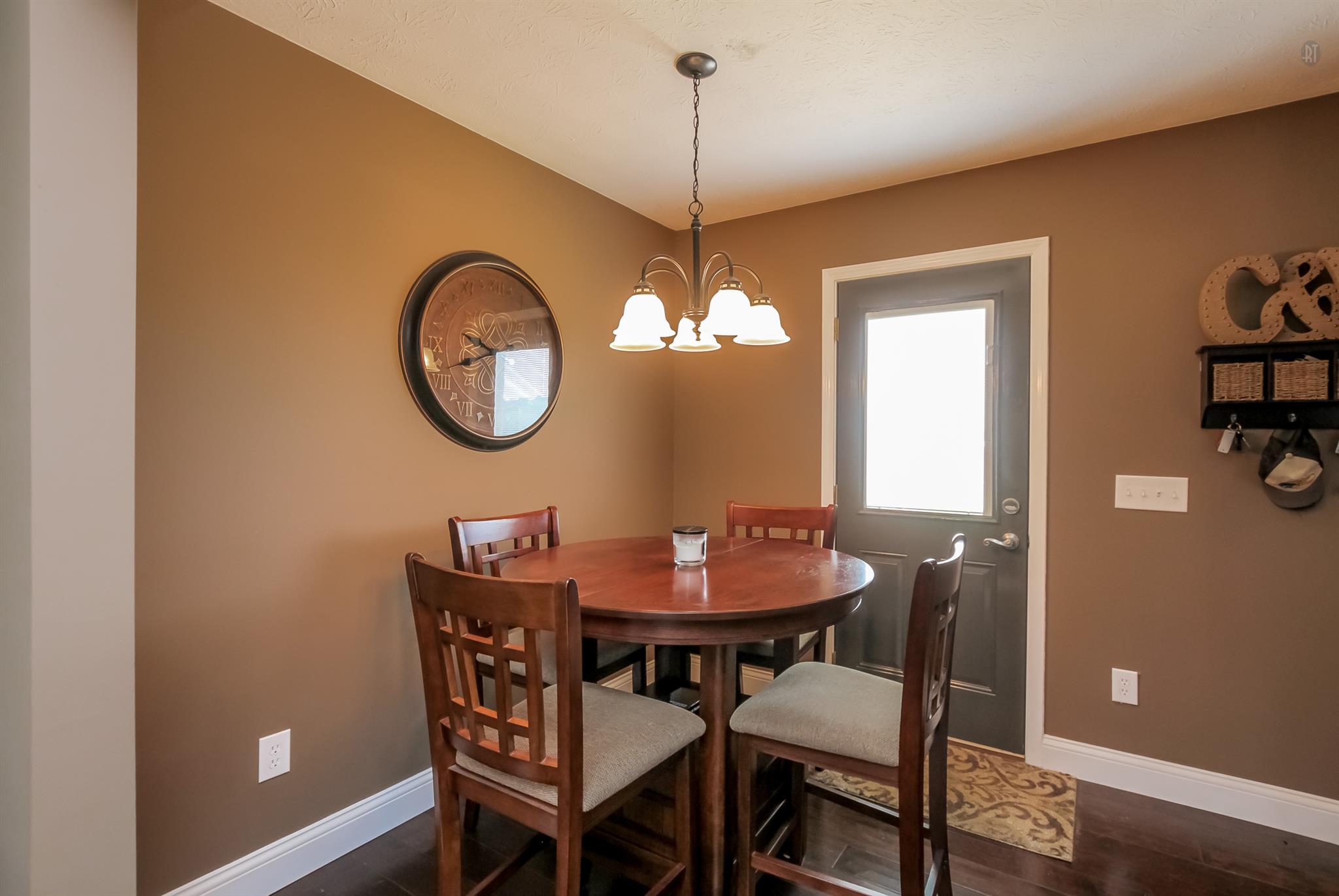 6144 South Lamont Road Springfield, TN 37172 - Photo 10 of 29 a dining room with furniture a window and wooden floor