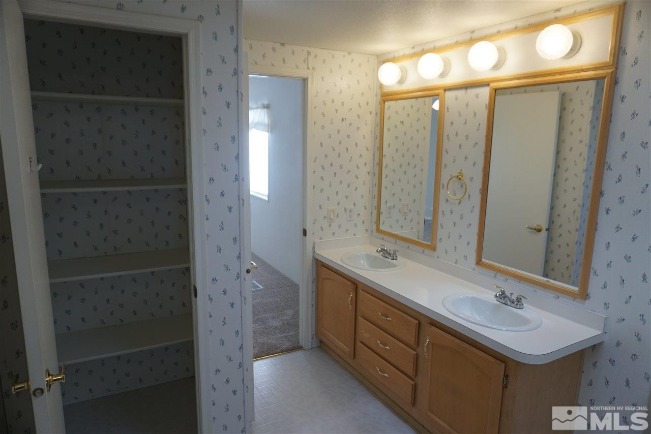 118 Walker Street Gardnerville, NV 89410 - Photo 14 of 20 a bathroom with a double vanity sink mirror and shower
