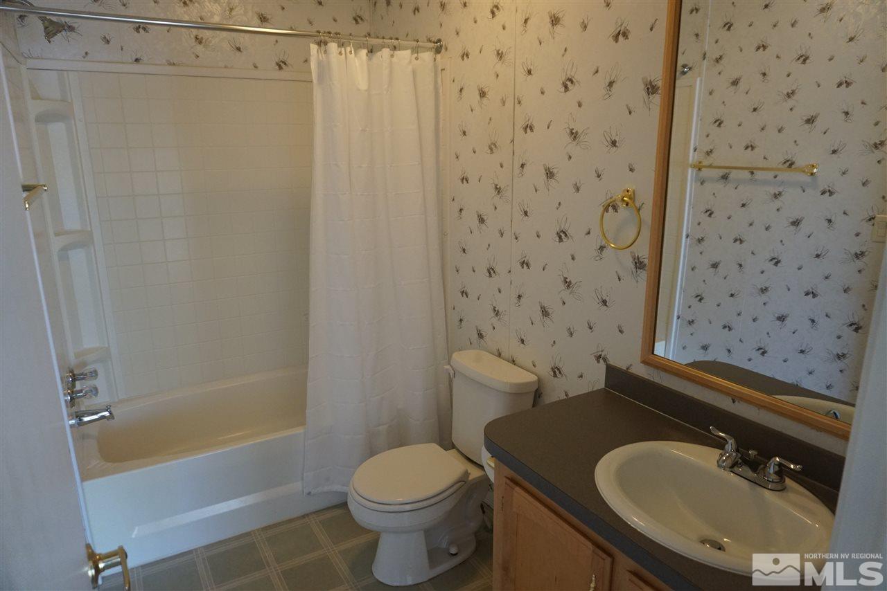 118 Walker Street Gardnerville, NV 89410 - Photo 15 of 20 a bathroom with a sink toilet and shower