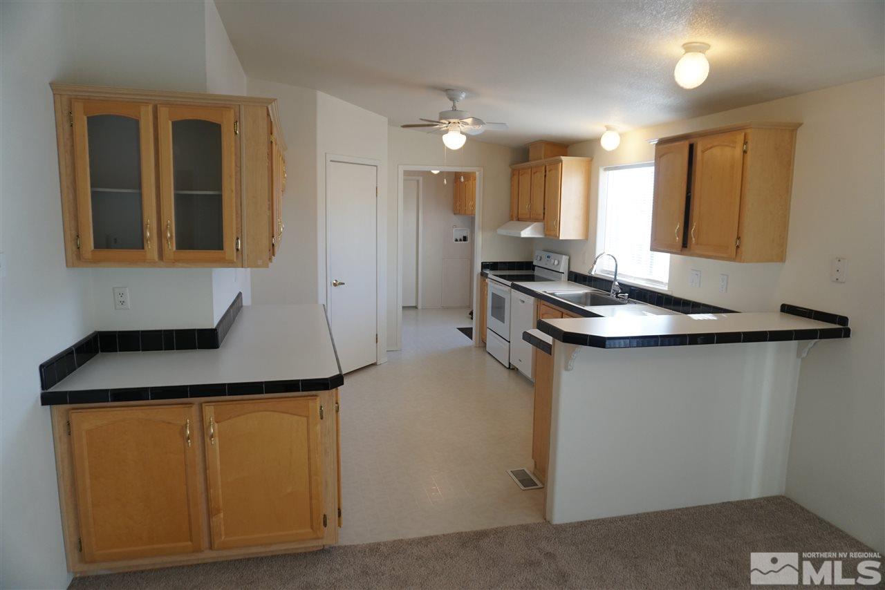 118 Walker Street Gardnerville, NV 89410 - Photo 4 of 20 a kitchen with a sink cabinets and wooden floor