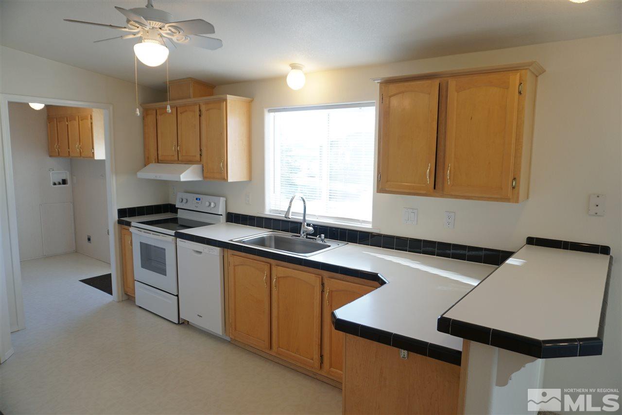 118 Walker Street Gardnerville, NV 89410 - Photo 5 of 20 a kitchen with a sink cabinets and window