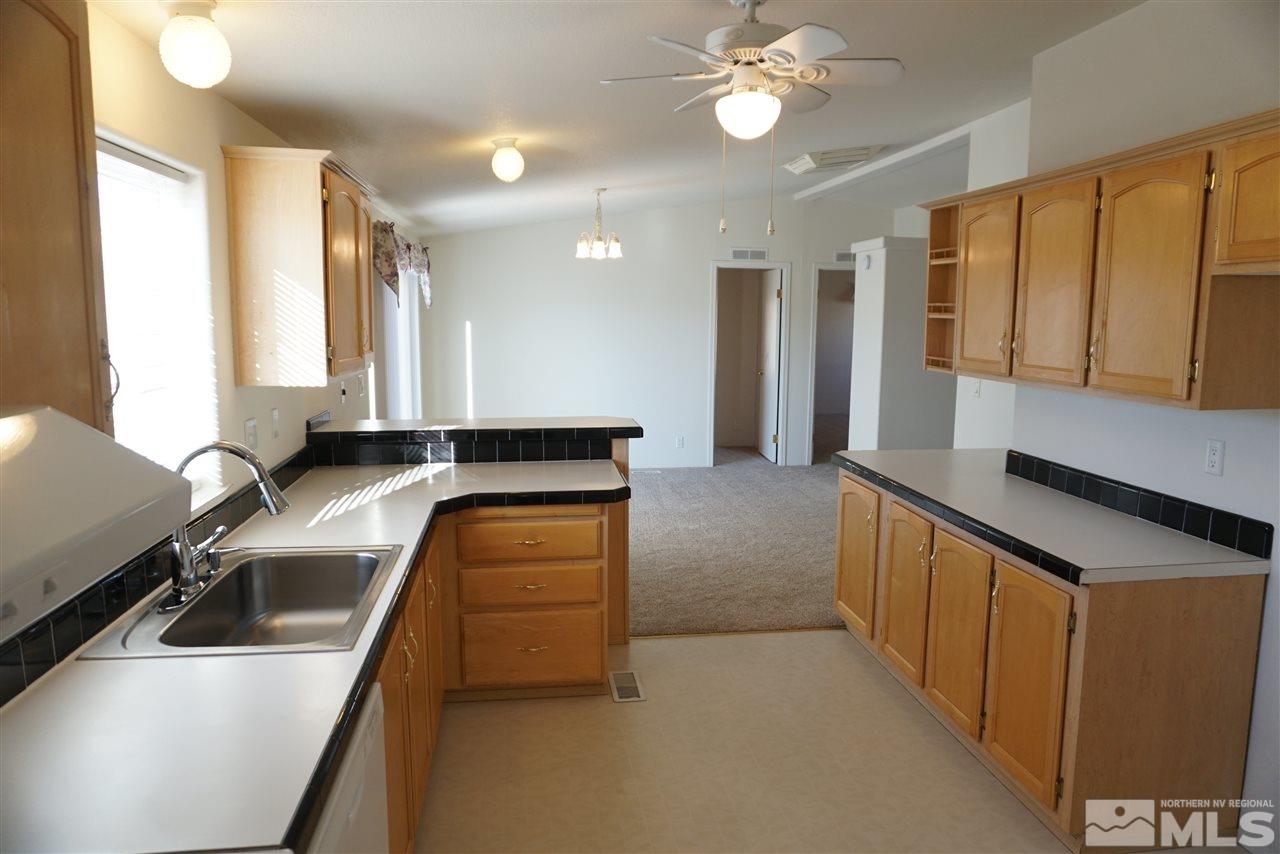 118 Walker Street Gardnerville, NV 89410 - Photo 6 of 20 a kitchen with a sink and a refrigerator