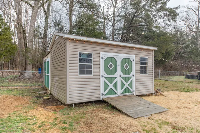 a view of a backyard with a chair and the tree