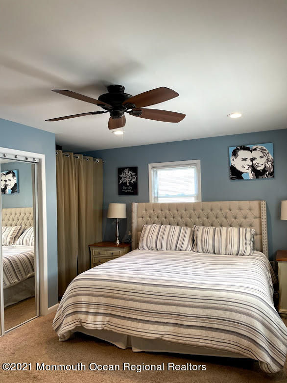 1314 Treeneedle Road Point Pleasant, NJ 08742 - Photo 25 of 62 a bedroom with a bed and a chandelier