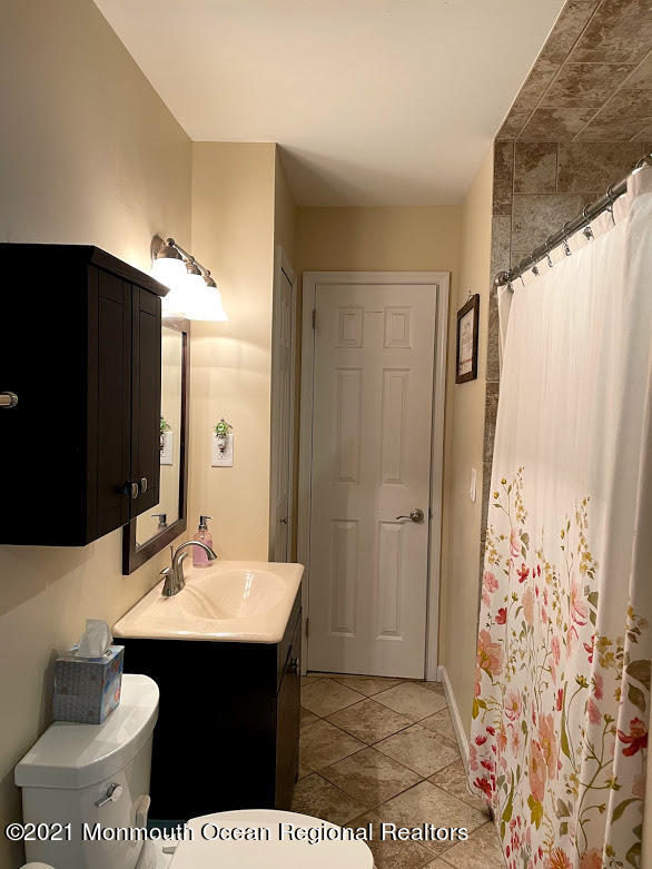 1314 Treeneedle Road Point Pleasant, NJ 08742 - Photo 29 of 62 a bathroom with a sink and a mirror