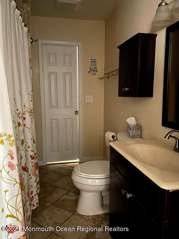 1314 Treeneedle Road Point Pleasant, NJ 08742 - Photo 33 of 62 a bathroom with a granite countertop sink toilet and shower