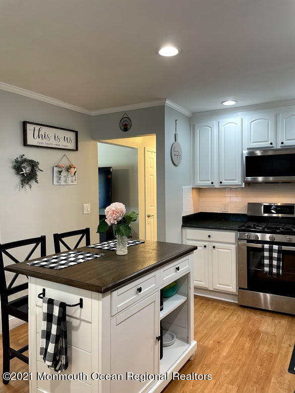 1314 Treeneedle Road Point Pleasant, NJ 08742 - Photo 5 of 62 a kitchen with granite countertop a sink cabinets and stainless steel appliances