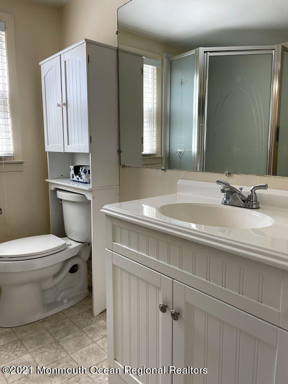 1314 Treeneedle Road Point Pleasant, NJ 08742 - Photo 45 of 62 a bathroom with a sink a toilet and mirror