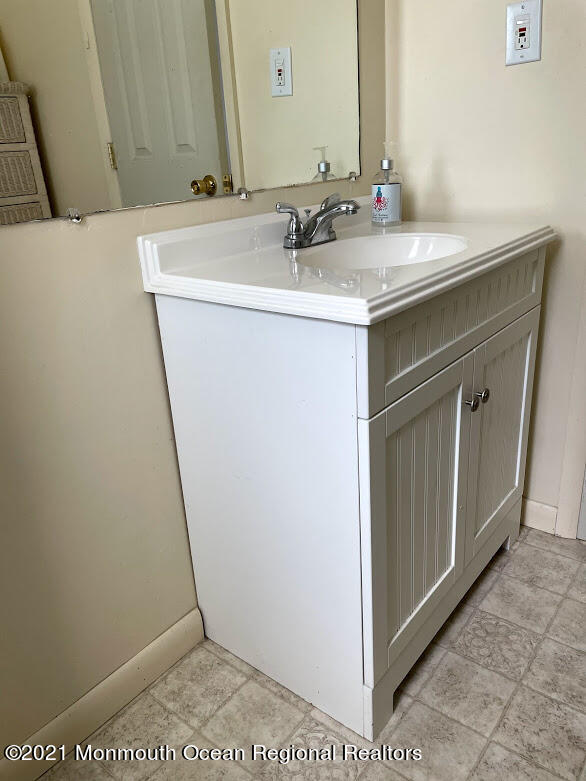 1314 Treeneedle Road Point Pleasant, NJ 08742 - Photo 47 of 62 a bathroom with a sink and a mirror