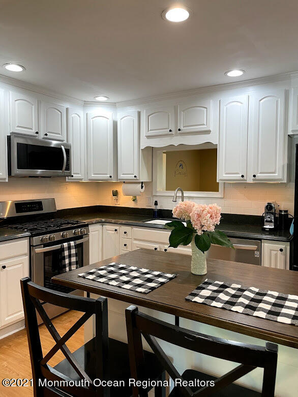 1314 Treeneedle Road Point Pleasant, NJ 08742 - Photo 9 of 62 a kitchen with a stove a sink and a microwave