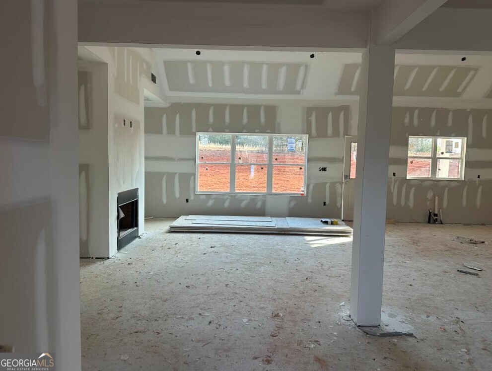 329 Ridgewood Road Jefferson, GA 30549 - Photo 2 of 12 an empty room with windows and fireplace
