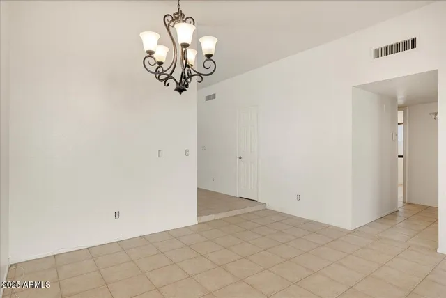 a view of a hallway with chandelier