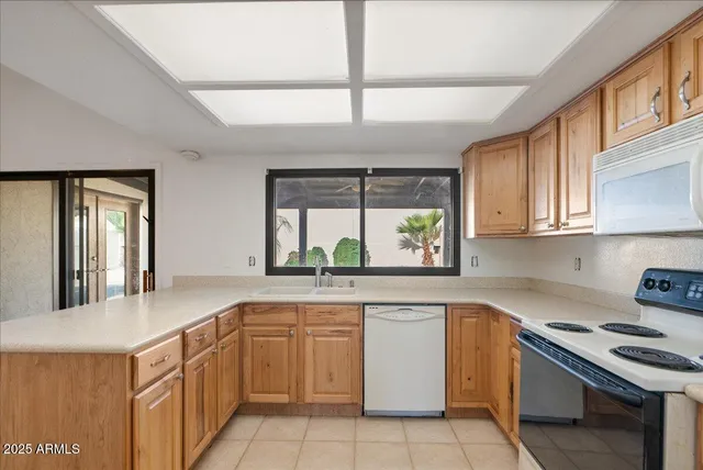 a kitchen with white cabinets and appliances