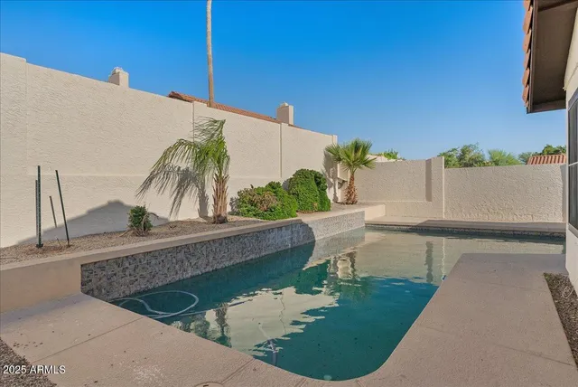 a view of a swimming pool with a patio