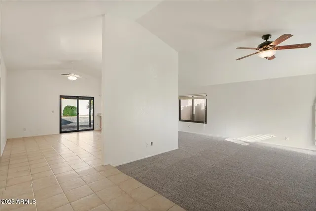 an empty room with windows and cabinet