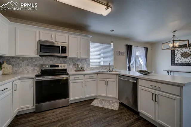 a kitchen with a sink stove and microwave