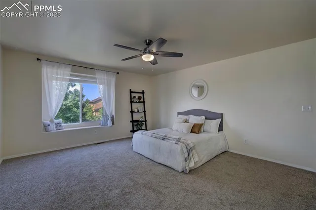 a bed room with a bed and a painting on the wall