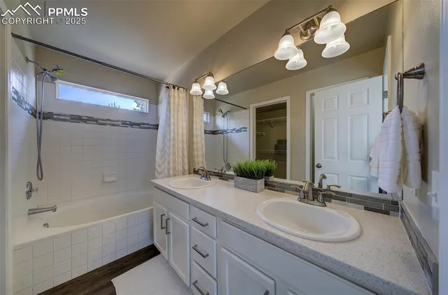 a bathroom with a double vanity sink and a mirror