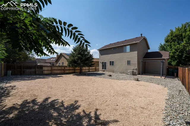 a front view of house with yard covered in snow