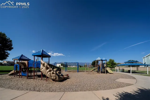 a view of a backyard with table and chairs